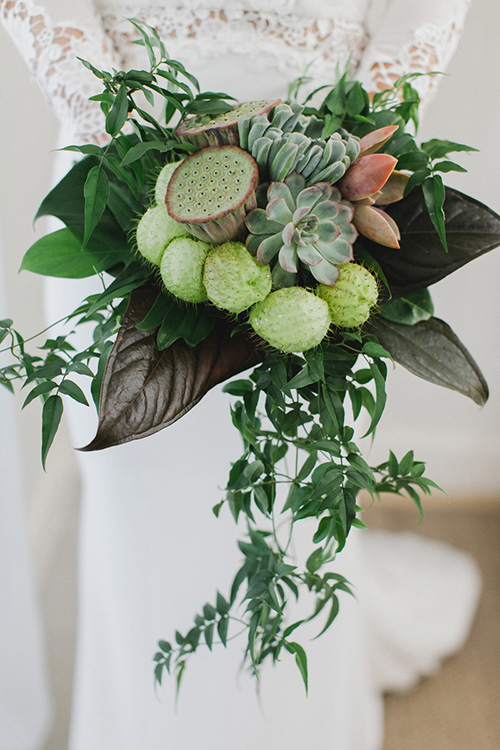 green wedding bouquet with lotus pods, succulents and tropical foliage